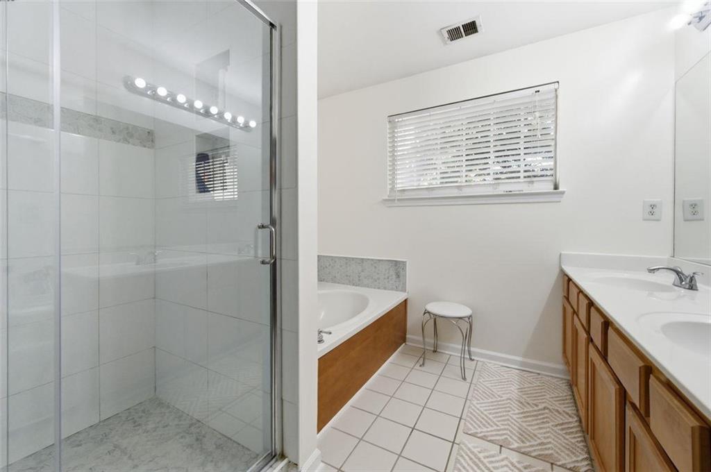 575 Reed Street Southeast Atlanta, GA 30312 - Photo 15 of 21 a bathroom with a tub a sink and a shower