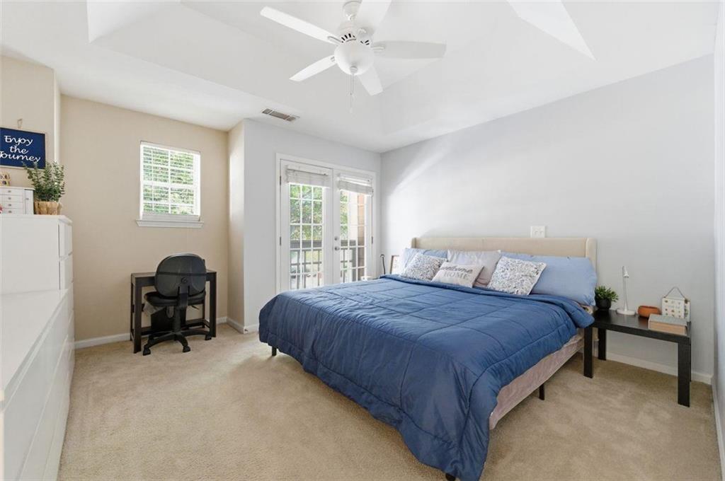 575 Reed Street Southeast Atlanta, GA 30312 - Photo 17 of 21 a bedroom with a bed and a chair