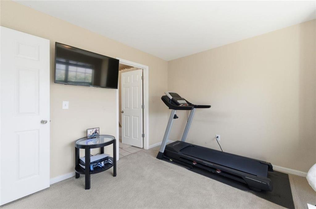 575 Reed Street Southeast Atlanta, GA 30312 - Photo 18 of 21 a room with gym equipment and a flat screen tv