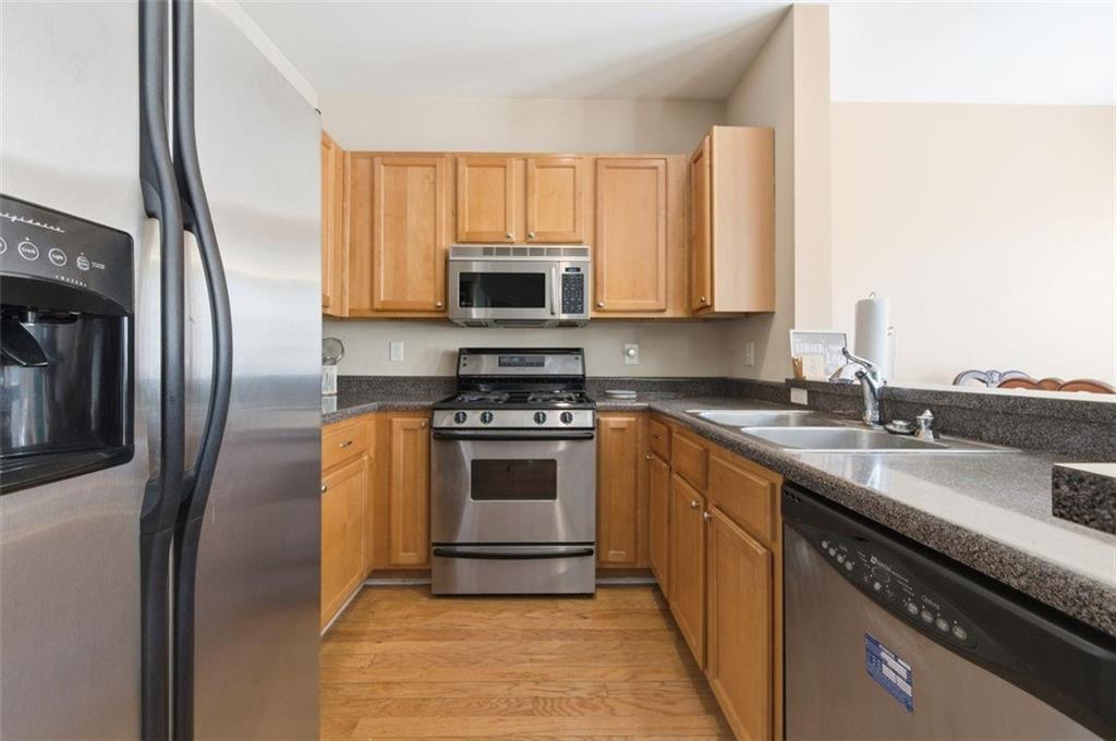 575 Reed Street Southeast Atlanta, GA 30312 - Photo 10 of 21 a kitchen with stainless steel appliances granite countertop a stove a sink and a refrigerator