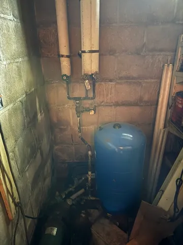 a backyard of a house with table and chairs and a barbeque