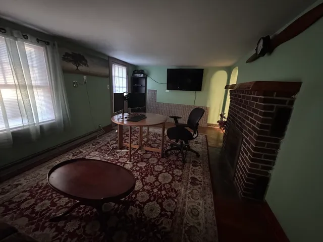 a living room with furniture rug and a window