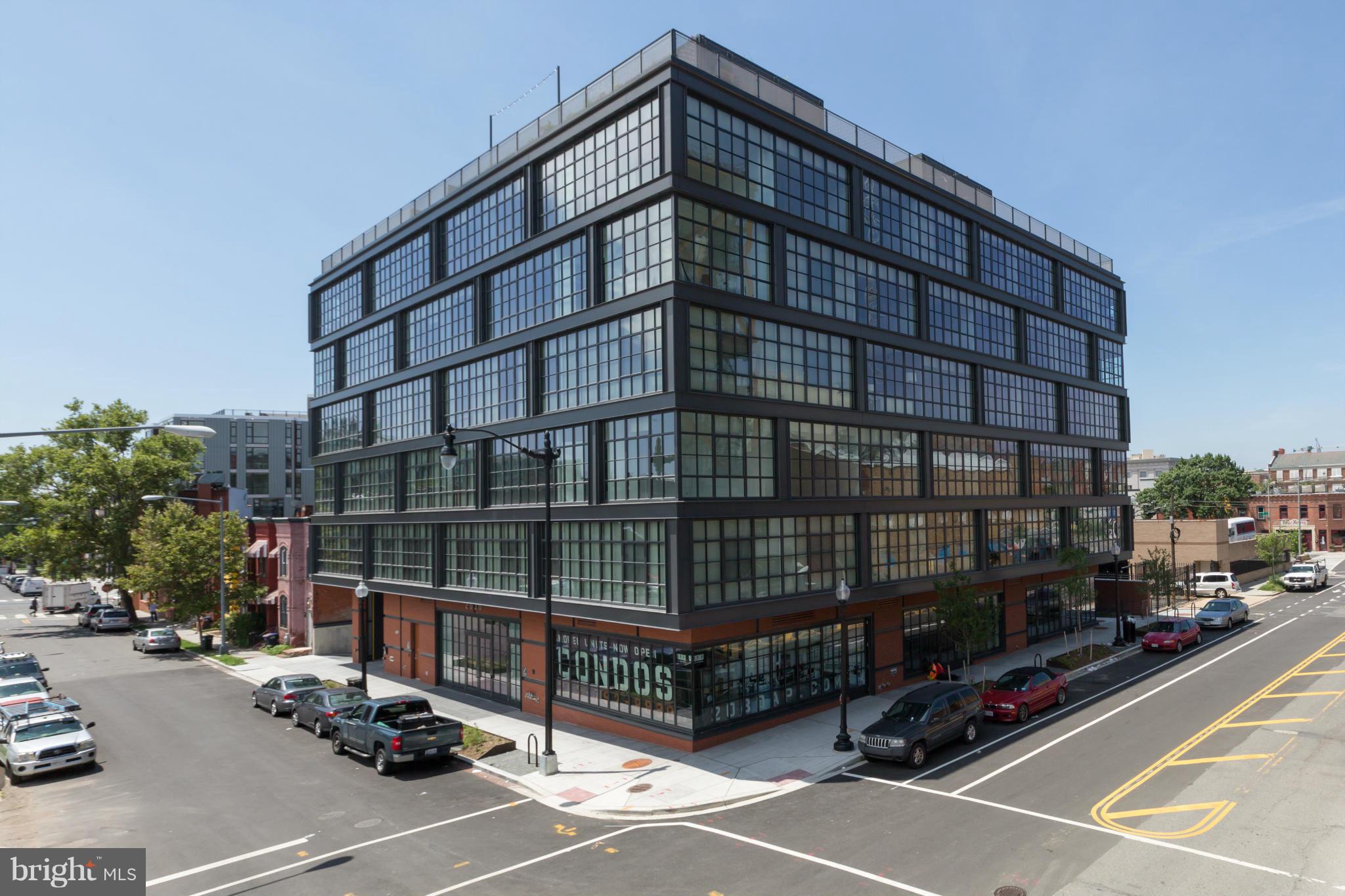 a view of a tall building next to a road