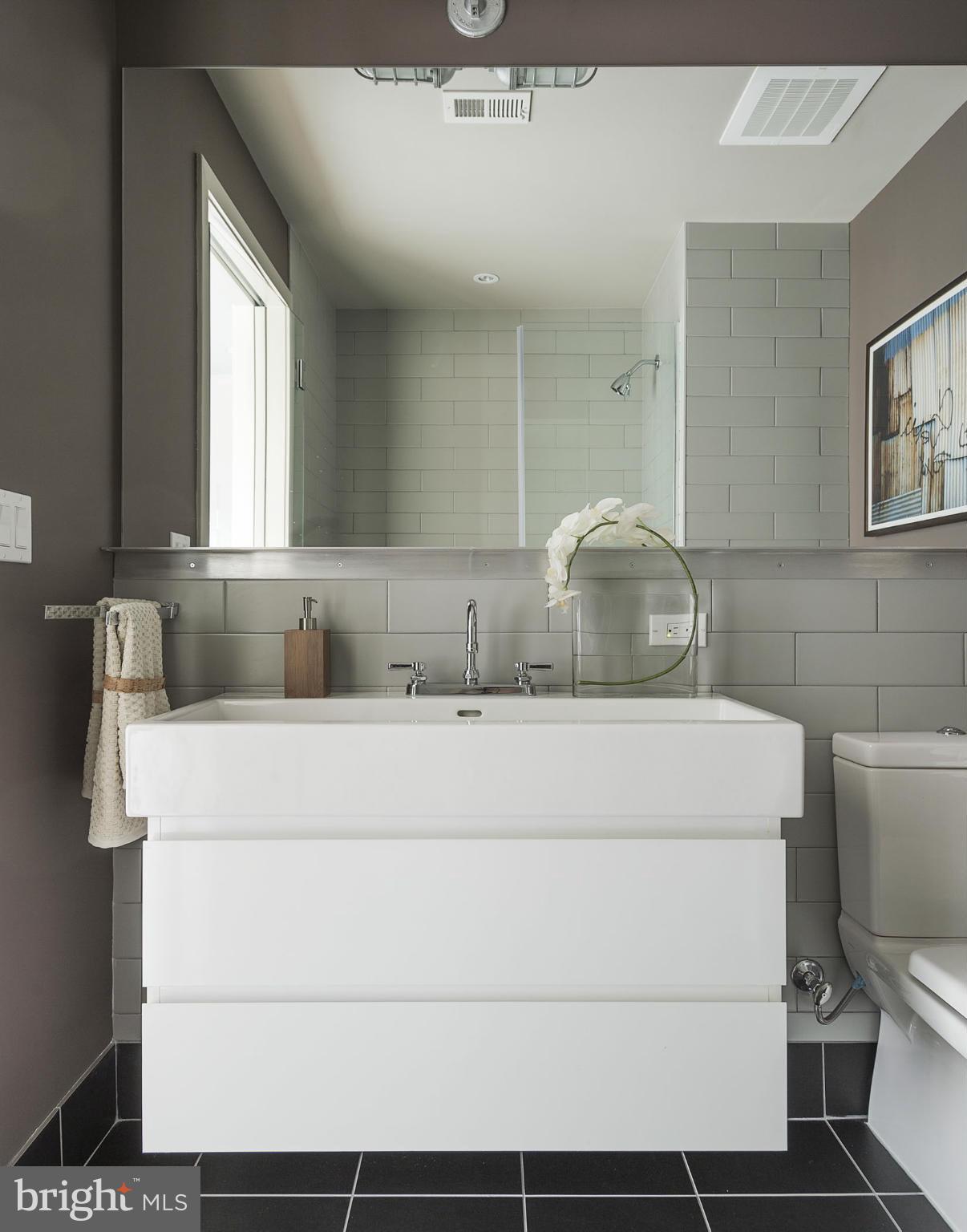 2030 8th Street Northwest, Unit 301 Washington, DC 20001 - Photo 11 of 20 a bathroom with a sink toilet and mirror