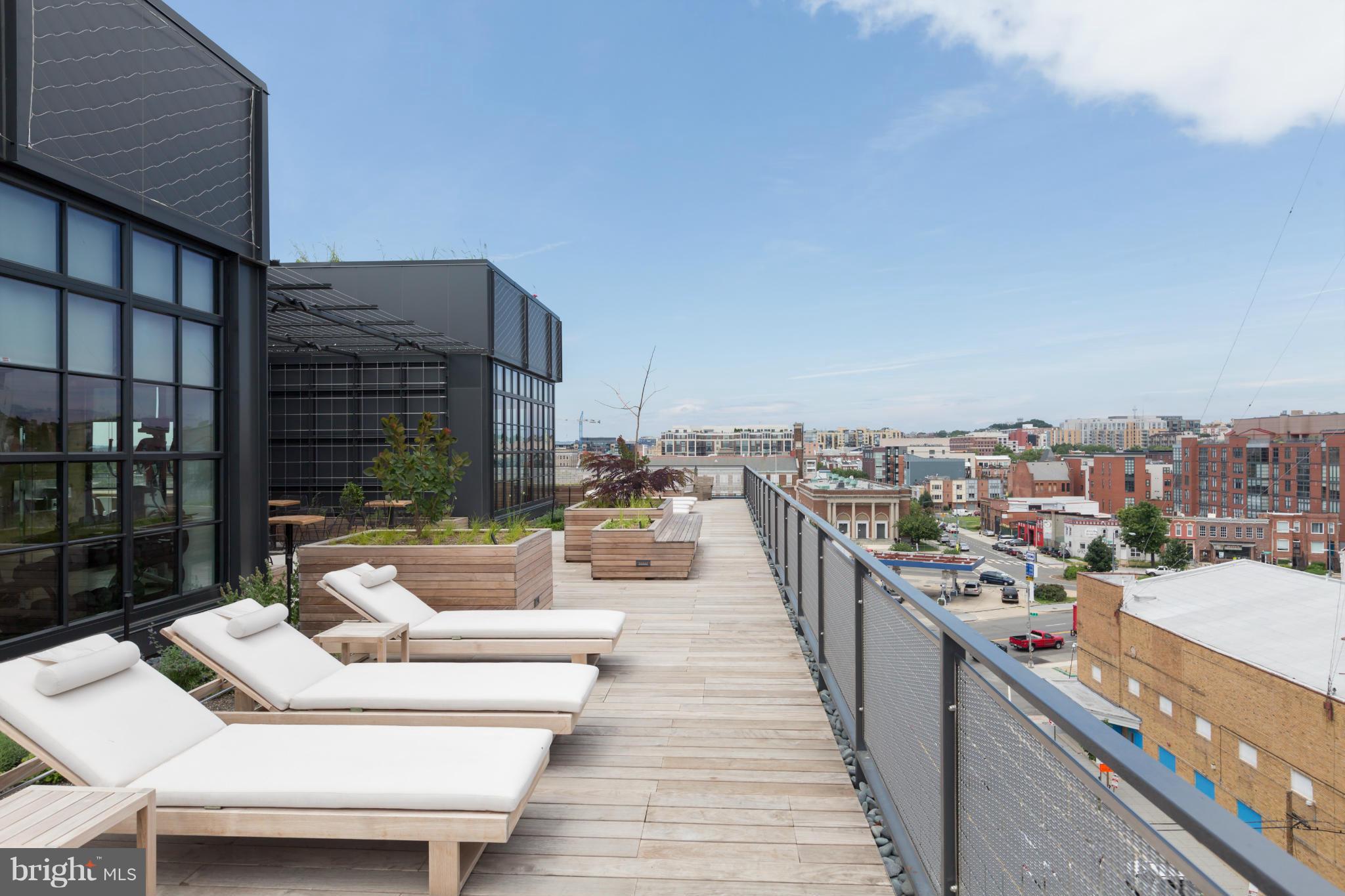 2030 8th Street Northwest, Unit 301 Washington, DC 20001 - Photo 17 of 20 a view of roof deck with a barbeque and couches chairs