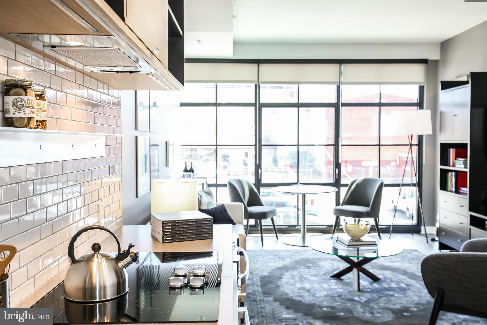 2030 8th Street Northwest, Unit 301 Washington, DC 20001 - Photo 6 of 20 a living room with furniture and floor to ceiling window