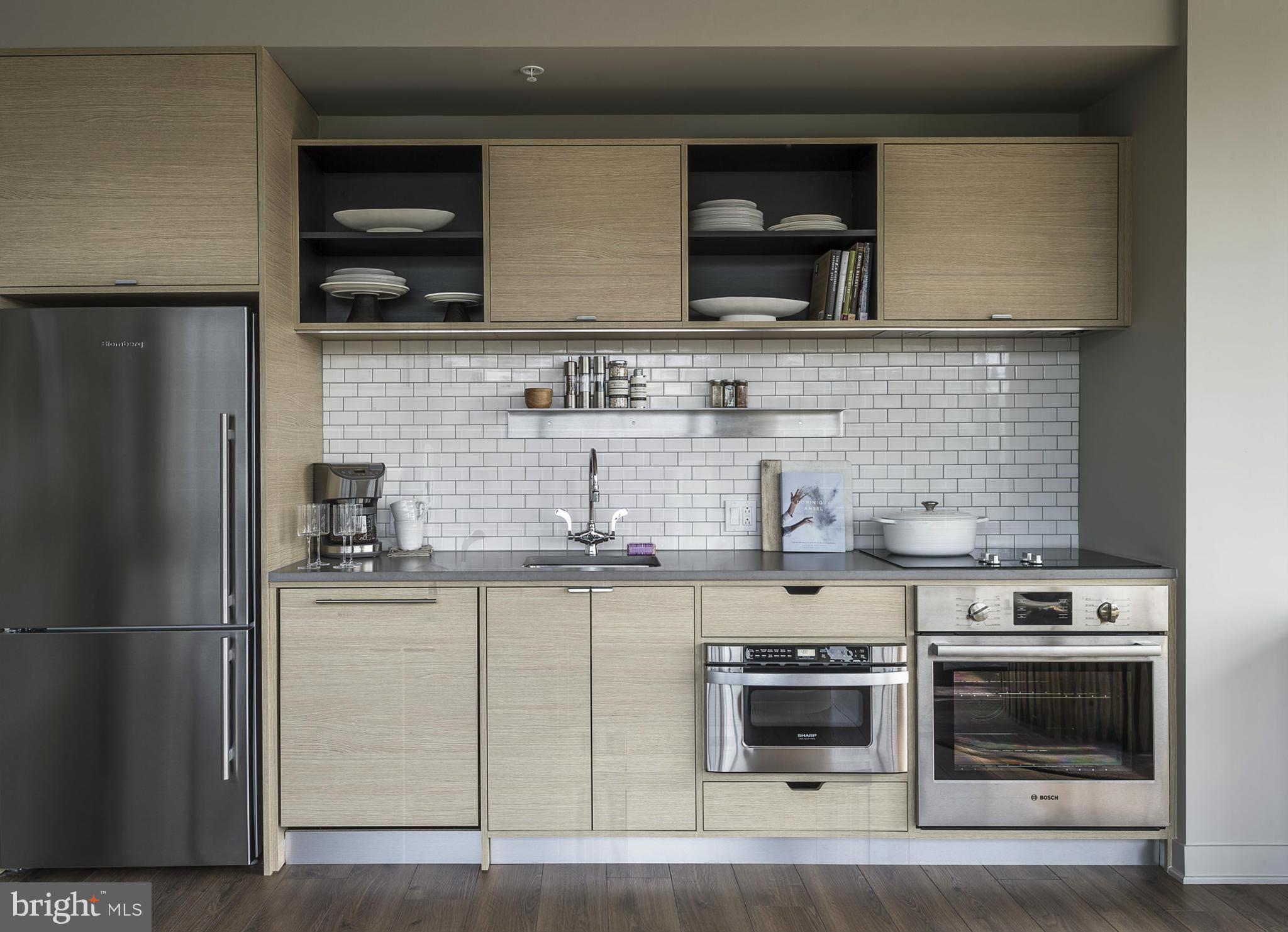 2030 8th Street Northwest, Unit 301 Washington, DC 20001 - Photo 8 of 20 a kitchen with stainless steel appliances granite countertop a stove and a microwave