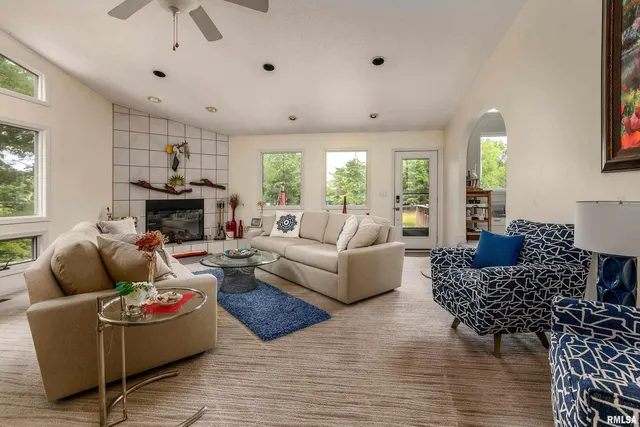 a living room with furniture and a chandelier