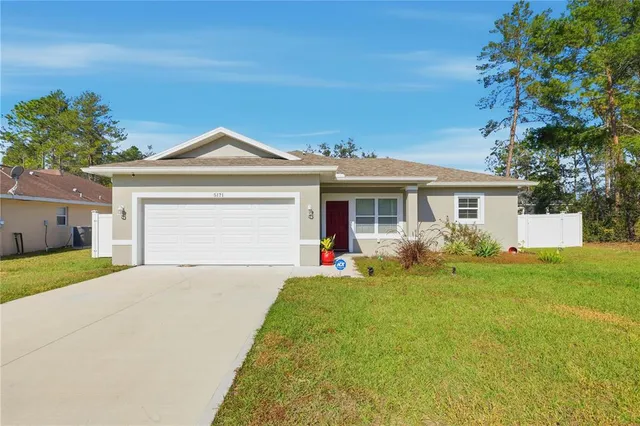 a front view of a house with a yard and porch