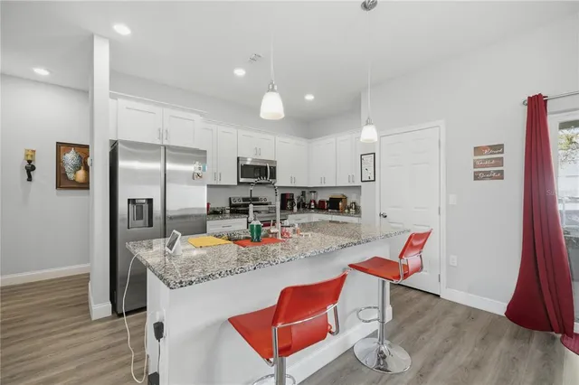 an aerial view of residential house with yard and swimming pool