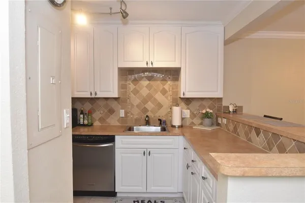 a kitchen with granite countertop white cabinets and white appliances