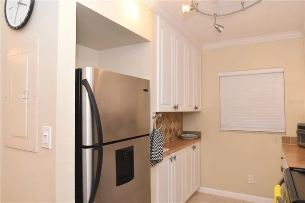 a kitchen with a refrigerator and a stove