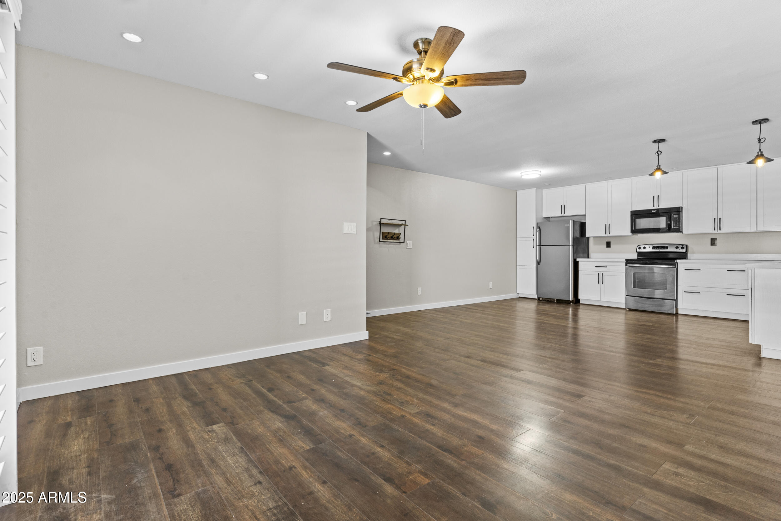 5525 East Thomas Road, Unit K16 Phoenix, AZ 85018 - Photo 12 of 36 a view of empty room with wooden floor and window