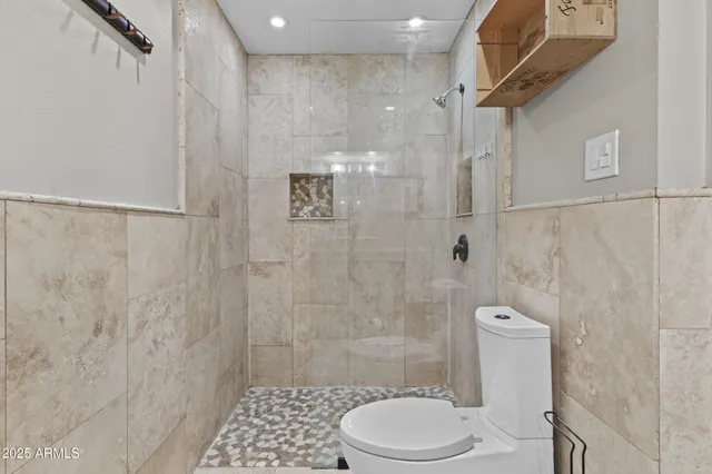 a bathroom with a toilet and a shower