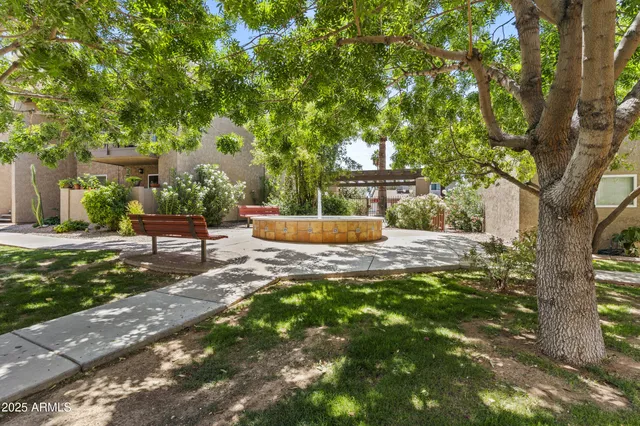 a wooden bench sitting in the middle of a yard