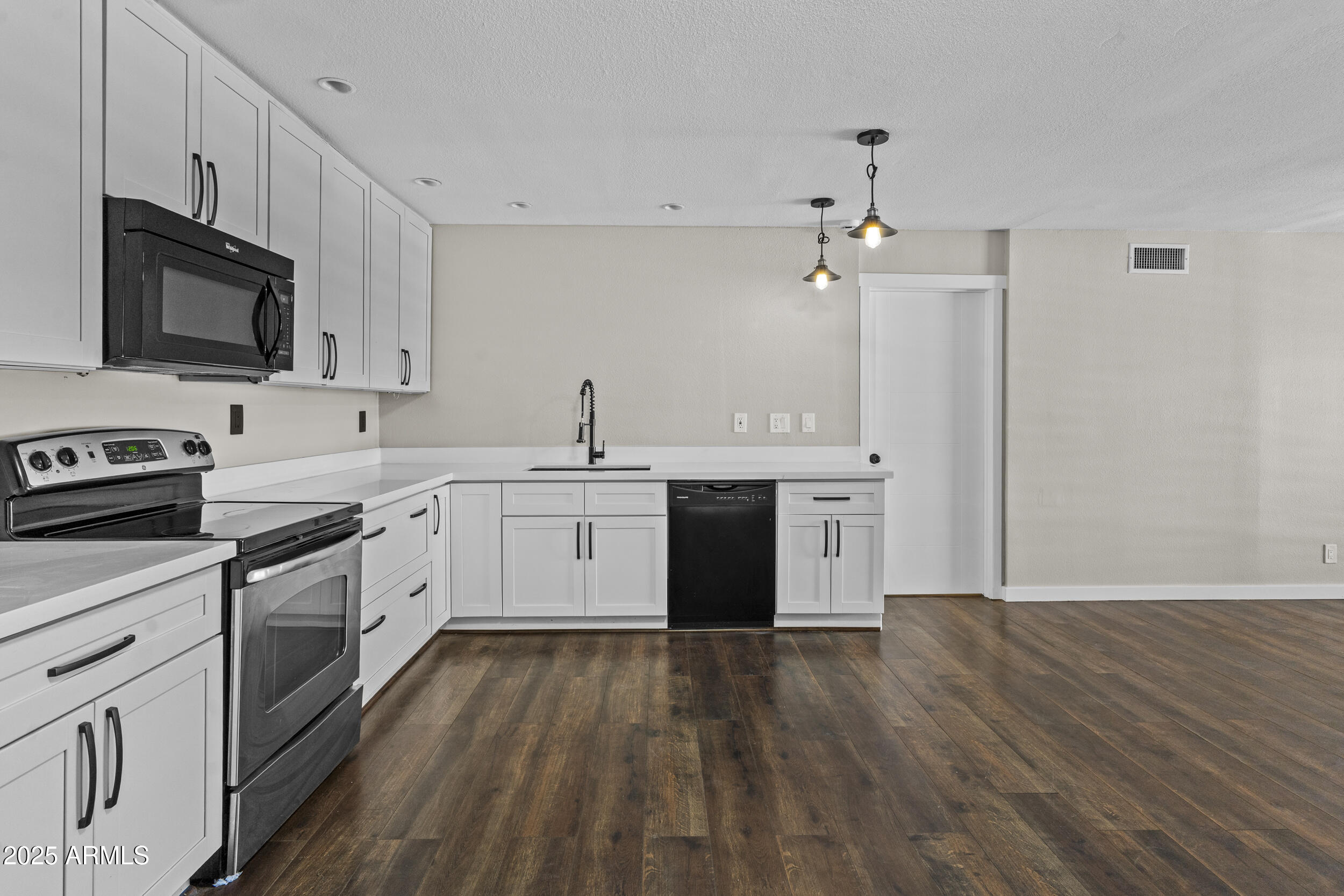 5525 East Thomas Road, Unit K16 Phoenix, AZ 85018 - Photo 2 of 36 a kitchen with a sink white cabinets and stainless steel appliances