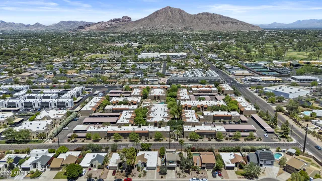 an aerial view of residential houses with city view