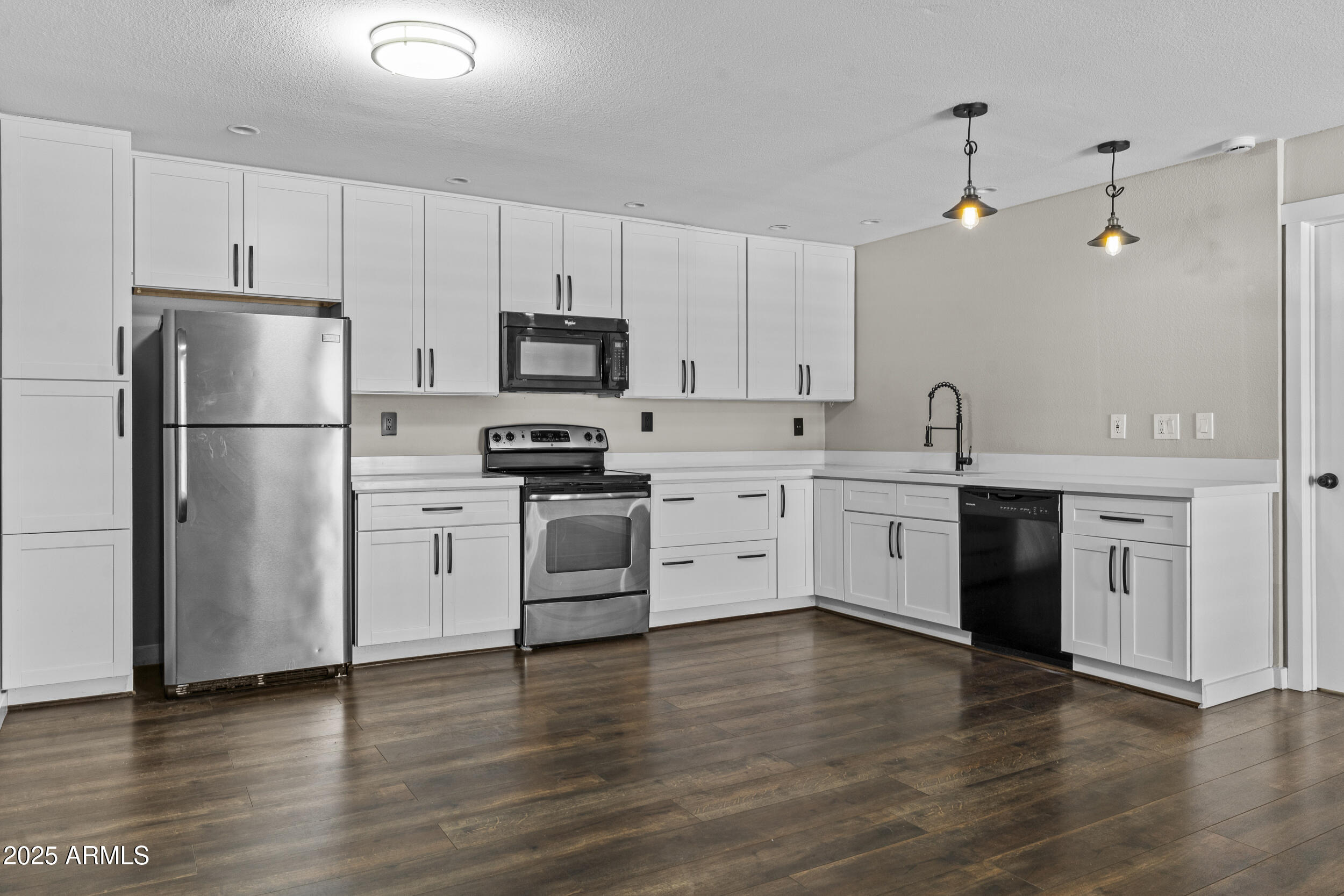 5525 East Thomas Road, Unit K16 Phoenix, AZ 85018 - Photo 6 of 36 a kitchen with stainless steel appliances a refrigerator sink and cabinets