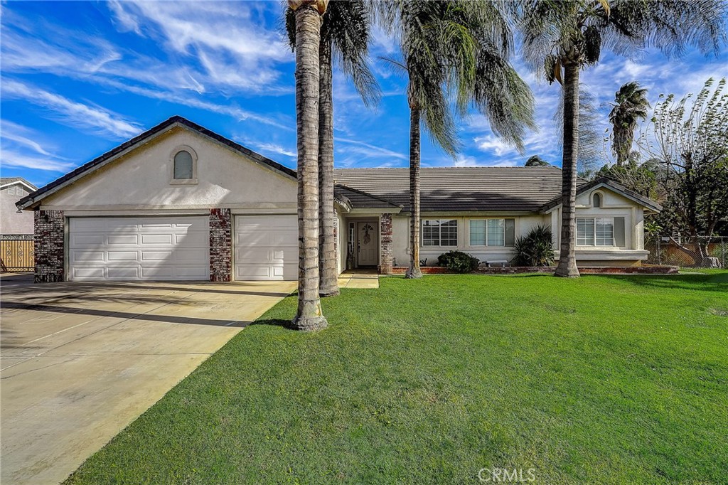 4920 Meadowland Drive Riverside, CA 92509 - Photo 1 of 28 a front view of a house with a garden and trees