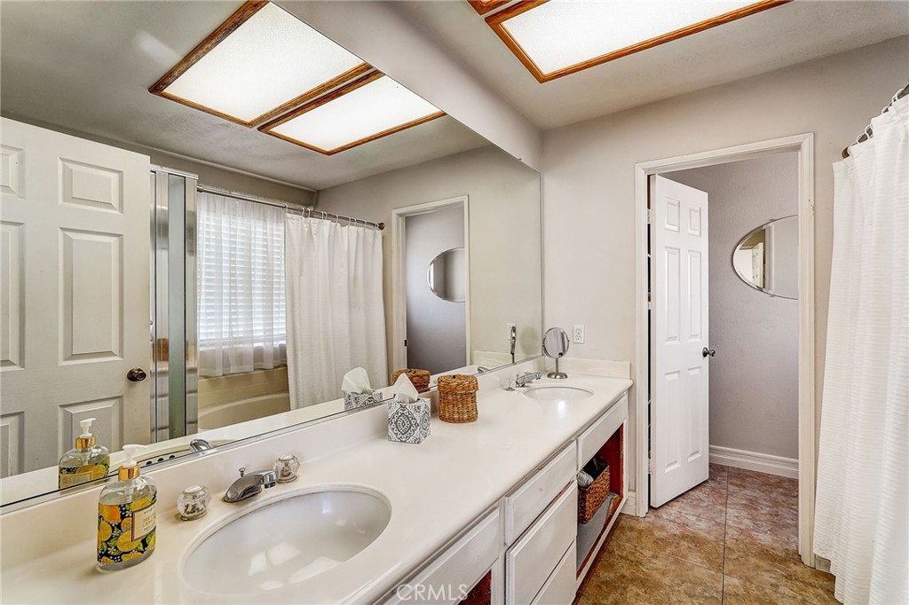 4920 Meadowland Drive Riverside, CA 92509 - Photo 16 of 28 a bathroom with a double vanity sink and a mirror
