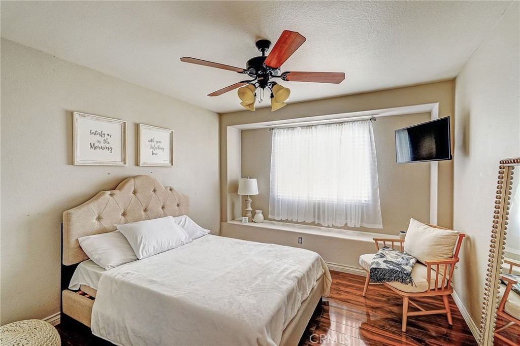 4920 Meadowland Drive Riverside, CA 92509 - Photo 17 of 28 a bedroom with a bed and a couch