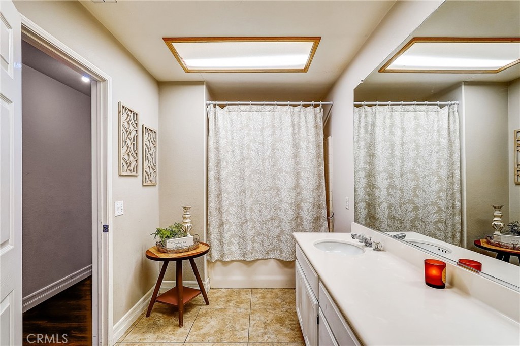 4920 Meadowland Drive Riverside, CA 92509 - Photo 19 of 28 a bathroom with a tub sink and a mirror