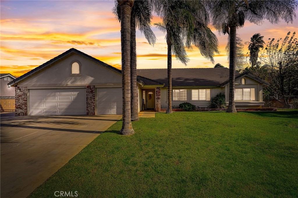 4920 Meadowland Drive Riverside, CA 92509 - Photo 27 of 28 a front view of a house with a garden and yard