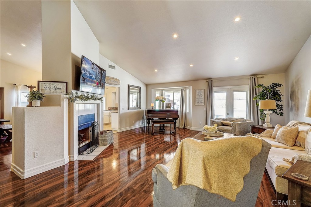 4920 Meadowland Drive Riverside, CA 92509 - Photo 3 of 28 a living room with furniture and a dining table with kitchen view