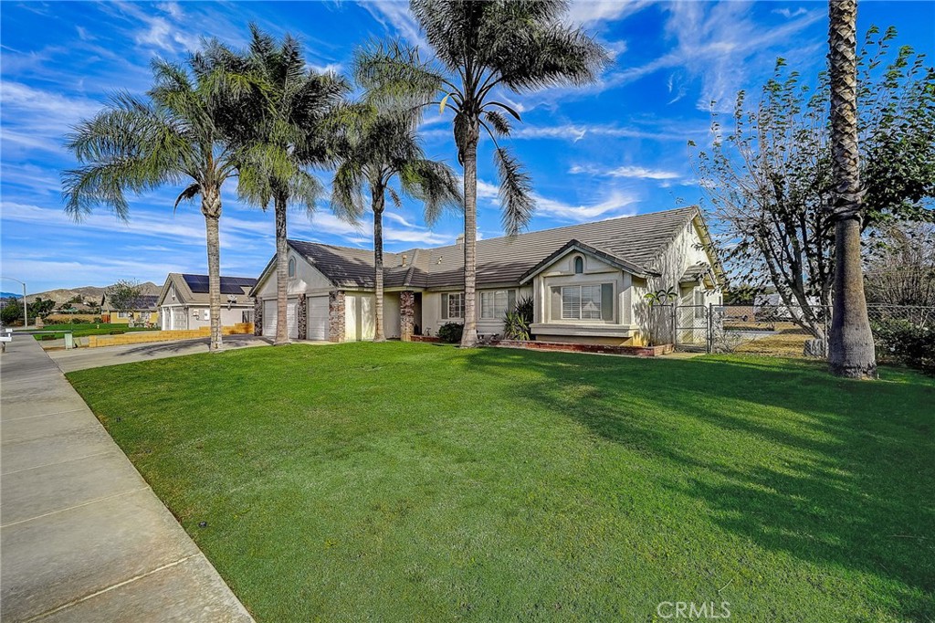 4920 Meadowland Drive Riverside, CA 92509 - Photo 5 of 28 a view of a house with a big yard and palm trees