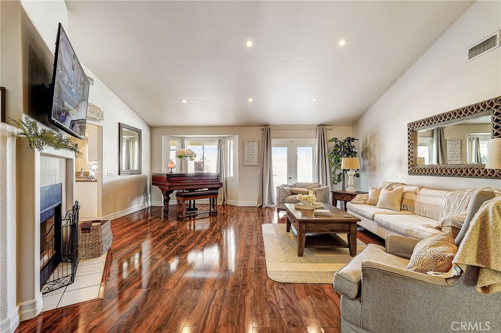4920 Meadowland Drive Riverside, CA 92509 - Photo 7 of 28 a living room with furniture a fireplace and a flat screen tv