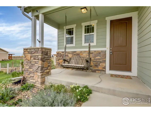 a backyard of a house with barbeque oven and outdoor seating
