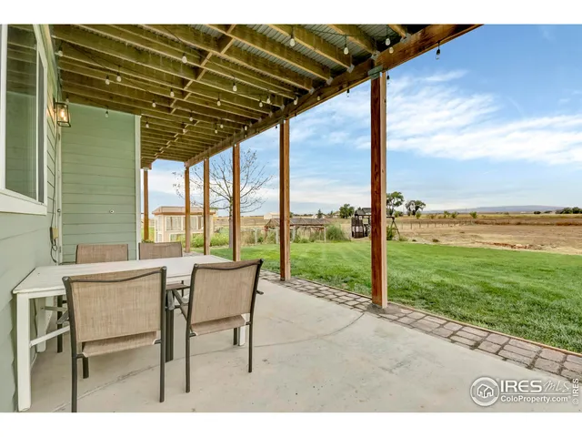 a roof deck with table and chairs and a couple of dining table and chairs