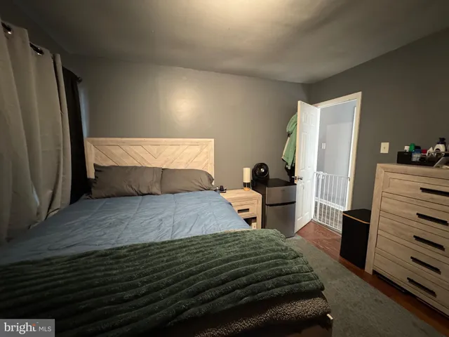a bedroom with a bed and dresser