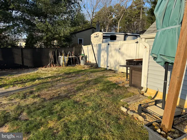 a view of a backyard with a table and chair