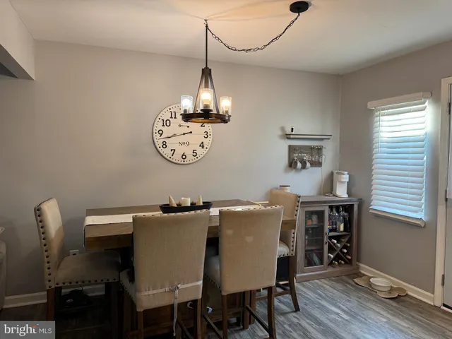 a view of a dining room with furniture wooden floor and a chandelier