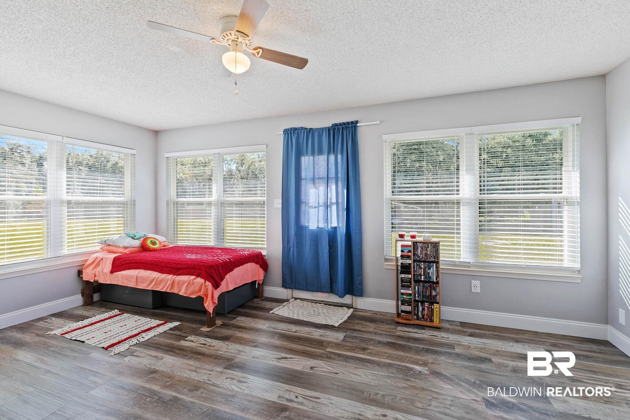 1510 South Juniper Street Foley, AL 36535 - Photo 25 of 36 Bedroom featuring a textured ceiling, dark wood-type flooring, and a ceiling fan