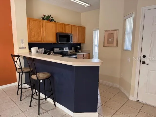 a kitchen with stainless steel appliances a sink cabinets and wooden floor