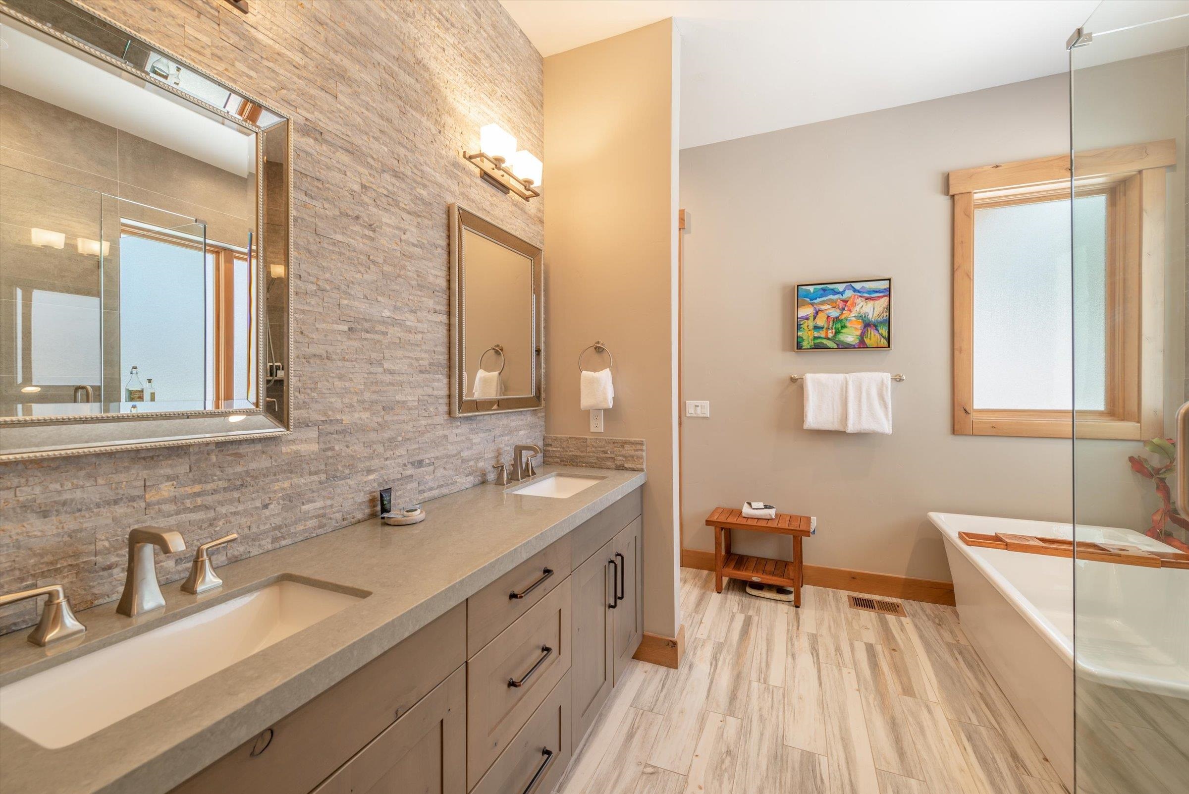 12427 Caleb Drive Truckee, CA 96161 - Photo 12 of 21 a spacious bathroom with a double vanity sink a mirror and a bathtub