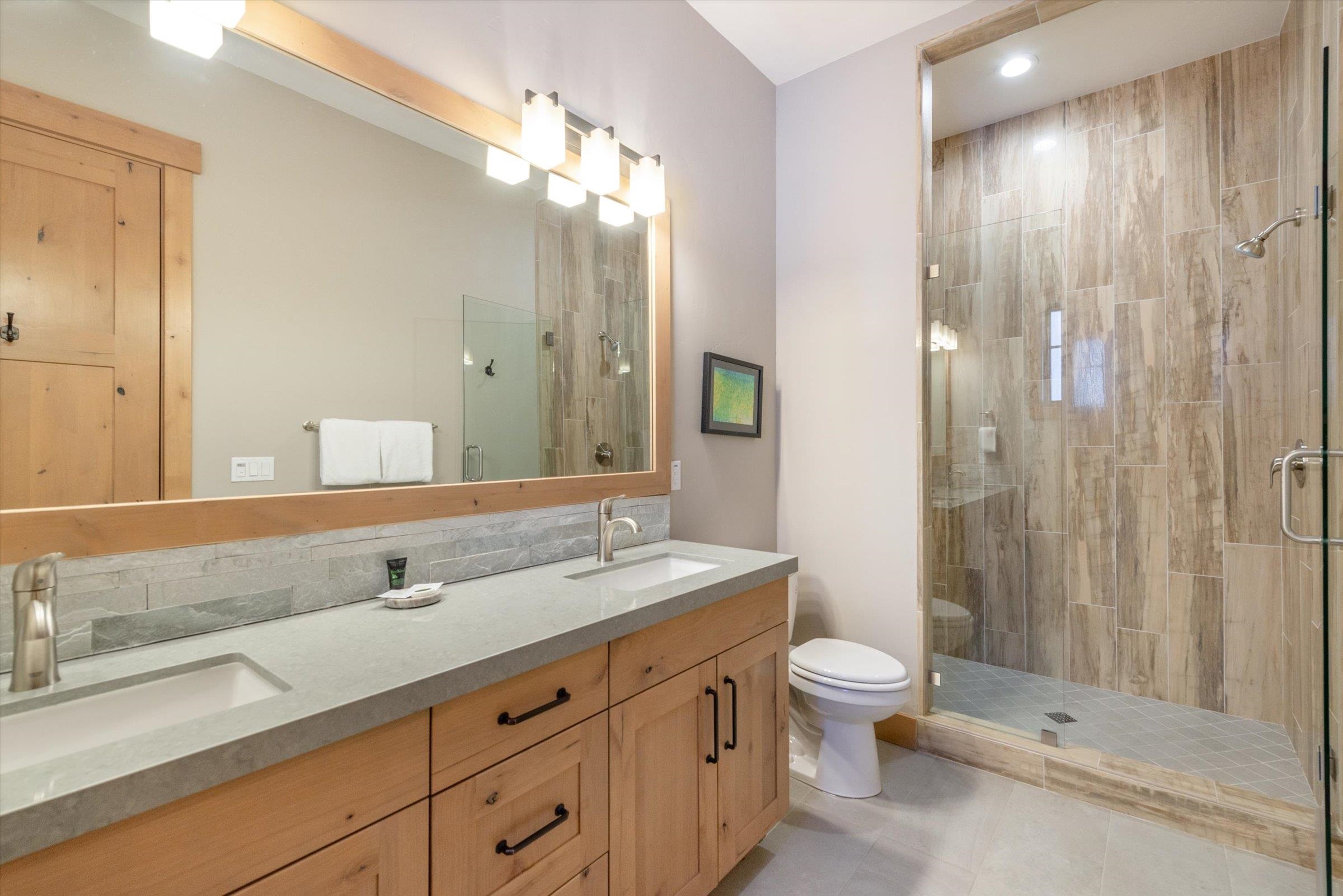 12427 Caleb Drive Truckee, CA 96161 - Photo 14 of 21 a bathroom with a double vanity sink toilet and shower