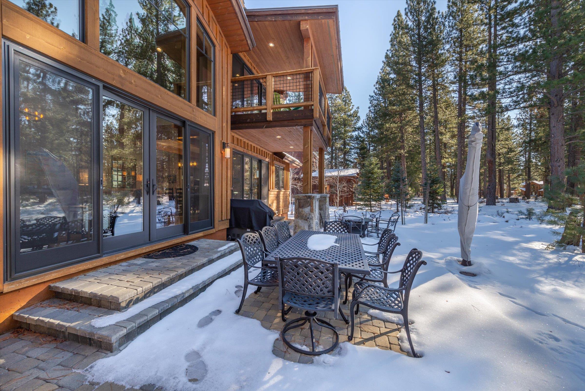 12427 Caleb Drive Truckee, CA 96161 - Photo 7 of 21 a view of a patio with a table and chairs and couches with wooden floor and fence