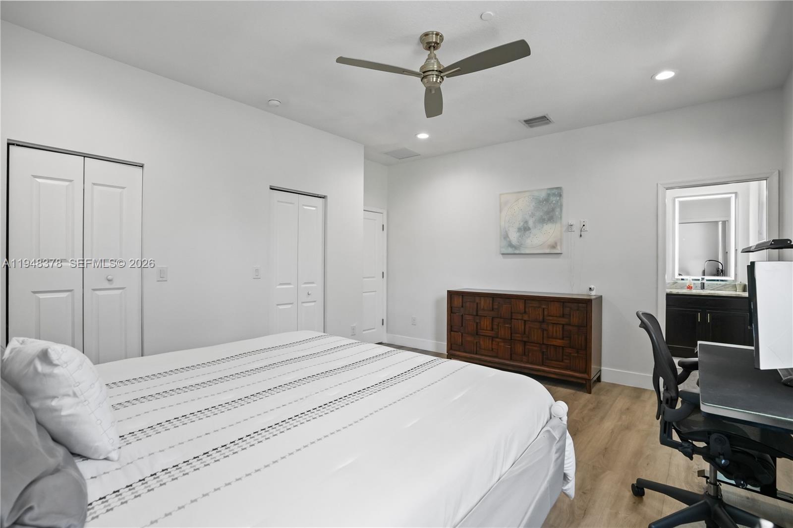 2913 Cascada Isle Way Cooper City, FL 33024 - Photo 17 of 50 a bedroom with a large bed and a chandelier