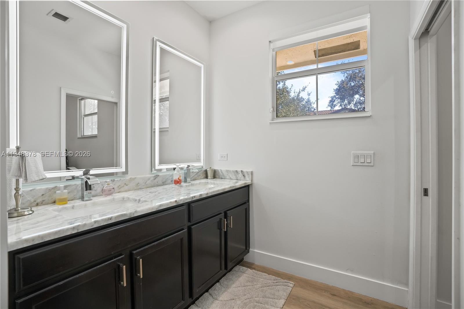 2913 Cascada Isle Way Cooper City, FL 33024 - Photo 19 of 50 a bathroom with a granite countertop sink a mirror and a