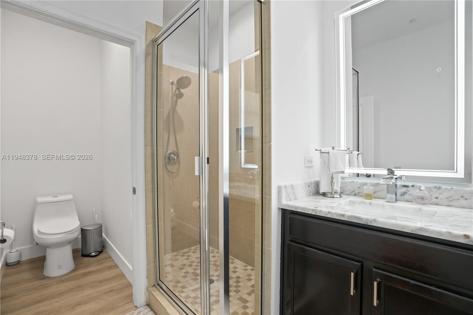 2913 Cascada Isle Way Cooper City, FL 33024 - Photo 20 of 50 a bathroom with a granite countertop sink toilet and shower