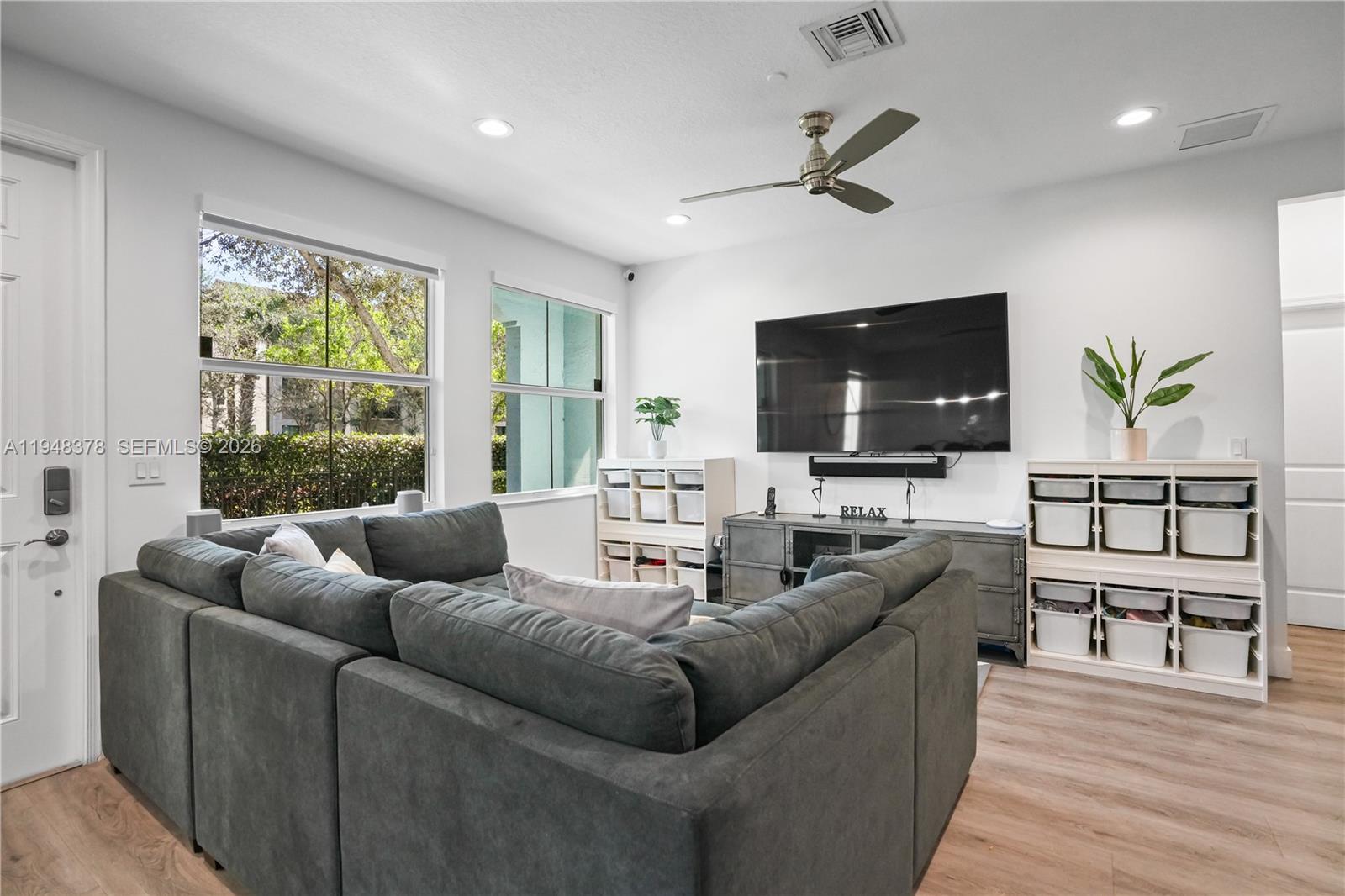 2913 Cascada Isle Way Cooper City, FL 33024 - Photo 2 of 50 a living room with furniture and a flat screen tv