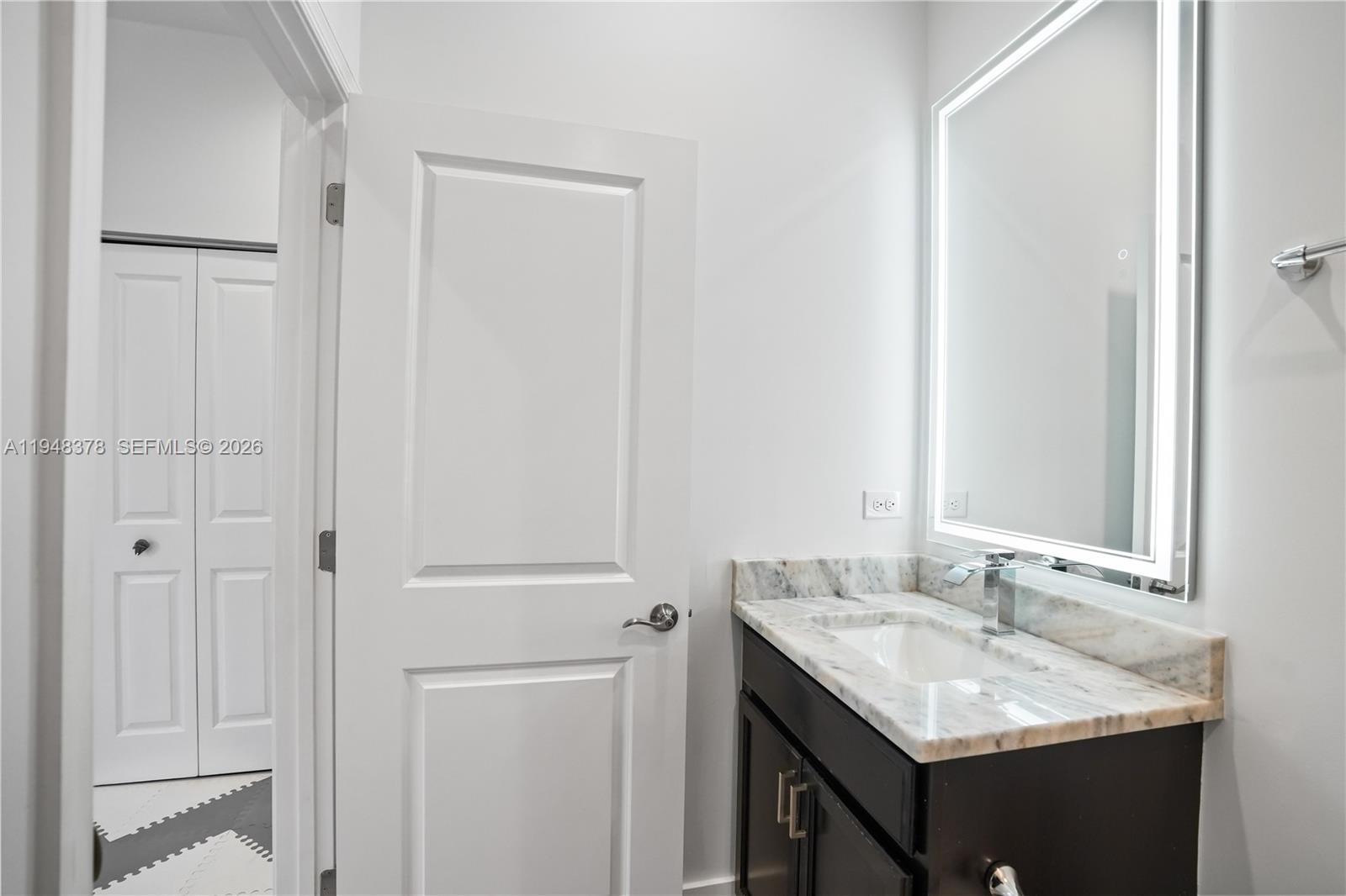 2913 Cascada Isle Way Cooper City, FL 33024 - Photo 26 of 50 a bathroom with a granite countertop sink and a mirror