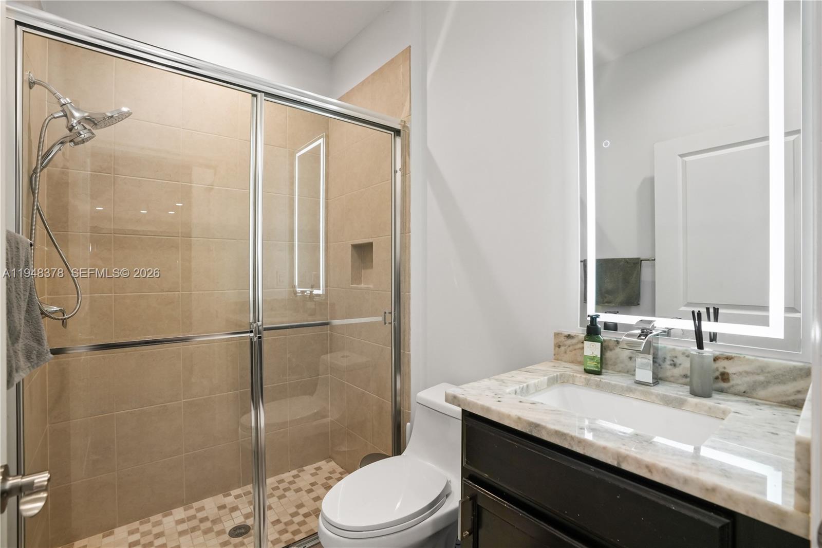 2913 Cascada Isle Way Cooper City, FL 33024 - Photo 30 of 50 a bathroom with a granite countertop sink toilet and shower