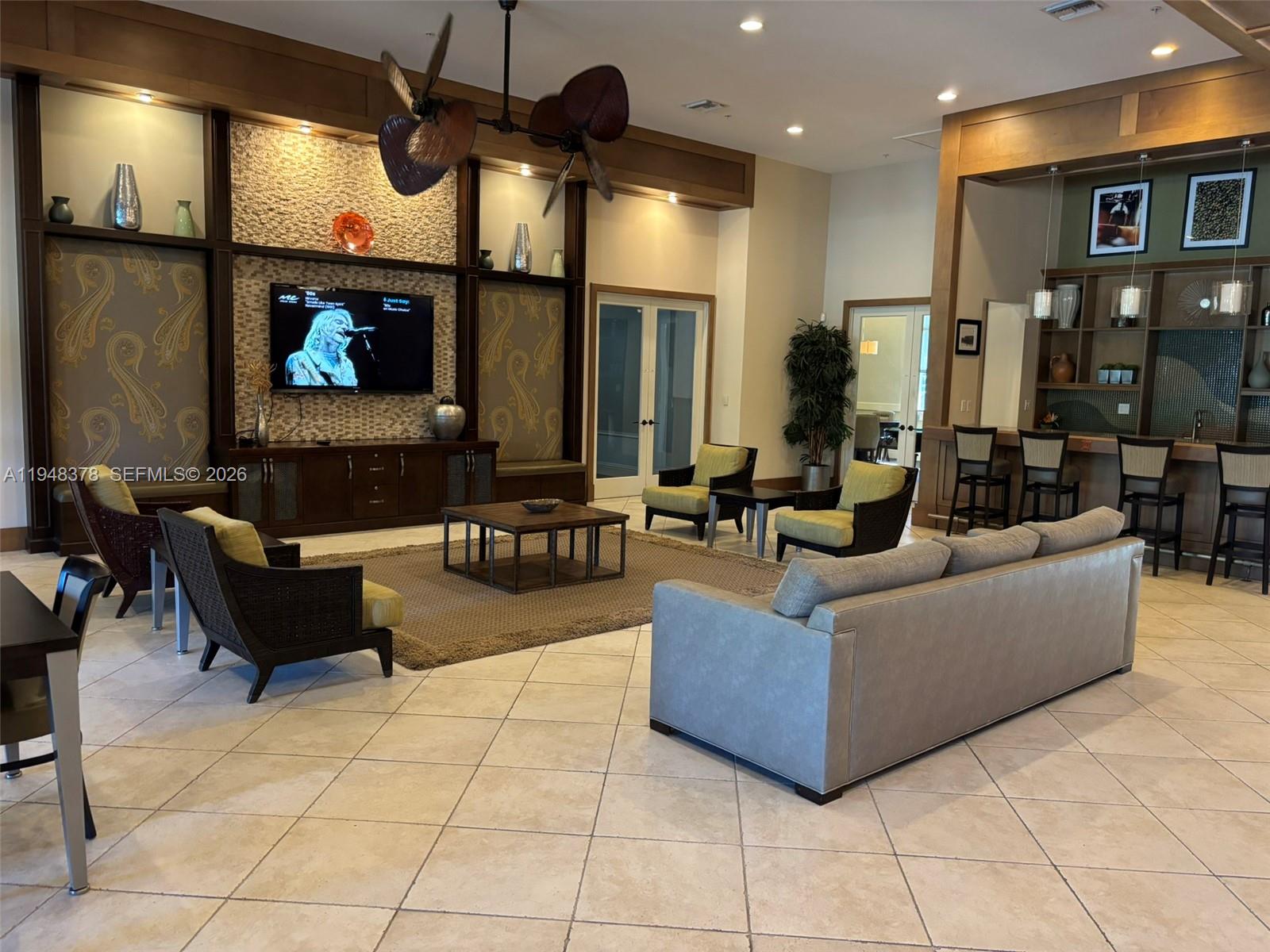 2913 Cascada Isle Way Cooper City, FL 33024 - Photo 39 of 50 a living room with furniture and a flat screen tv