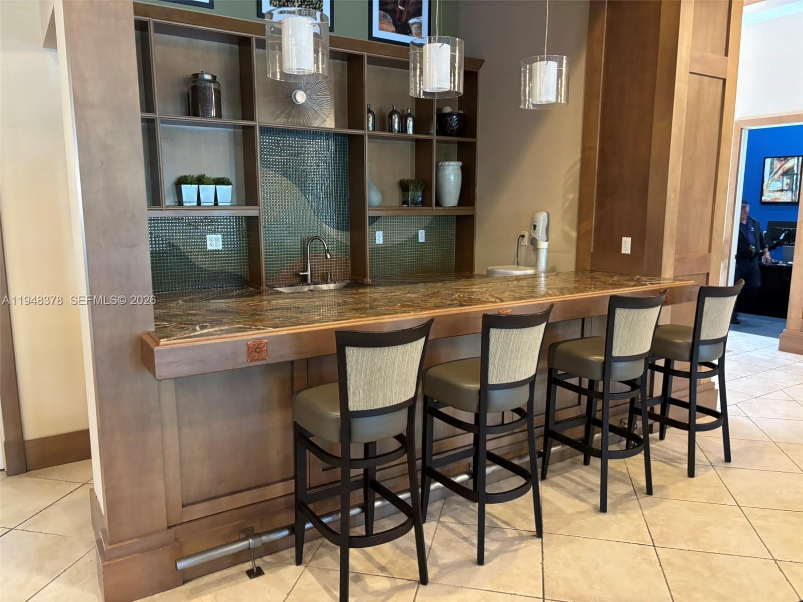 2913 Cascada Isle Way Cooper City, FL 33024 - Photo 42 of 50 a dining table with chairs and cabinets