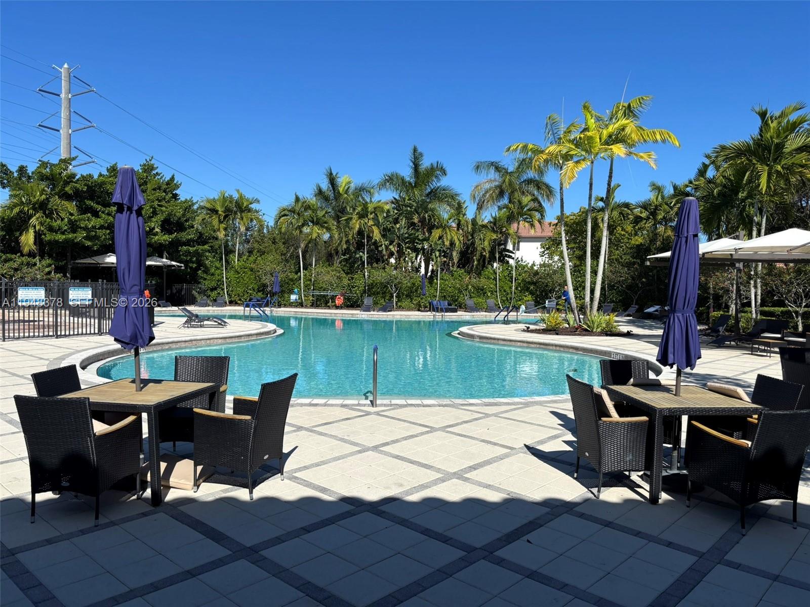 2913 Cascada Isle Way Cooper City, FL 33024 - Photo 45 of 50 a view of a lake with a table and chairs