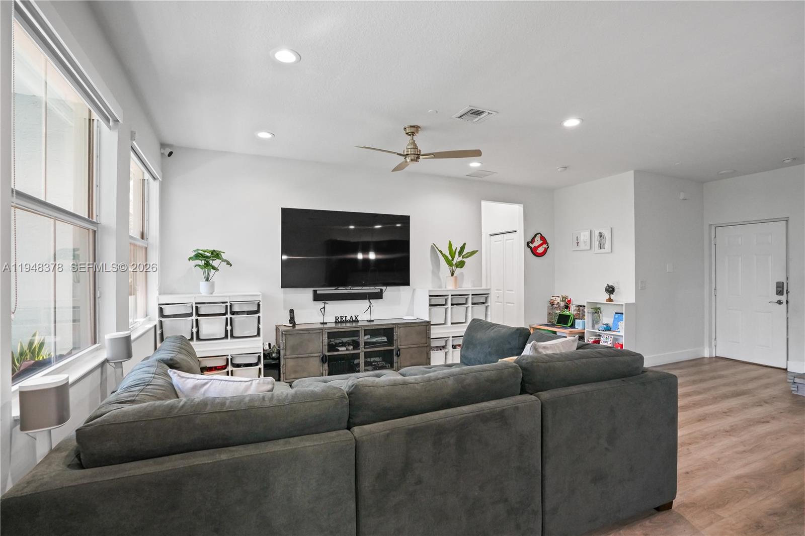 2913 Cascada Isle Way Cooper City, FL 33024 - Photo 5 of 50 a living room with furniture a flat screen tv and a window